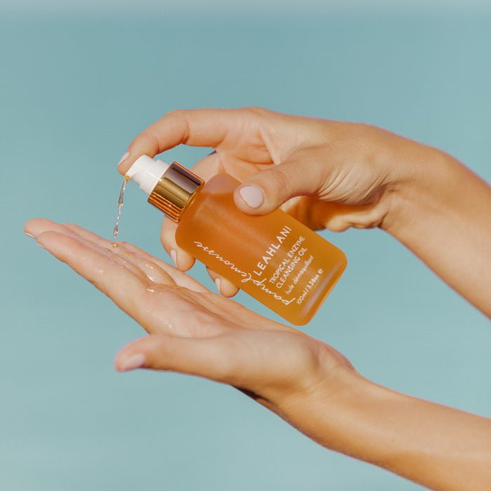 Pamplemousse Tropical Enzyme Cleansing Oil held in hand