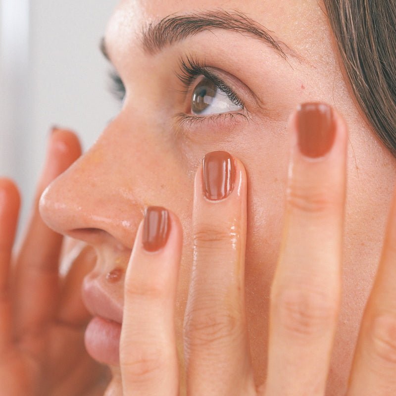 Wildcrafted Organics Rejuvenating Serum - Model applying serum close up