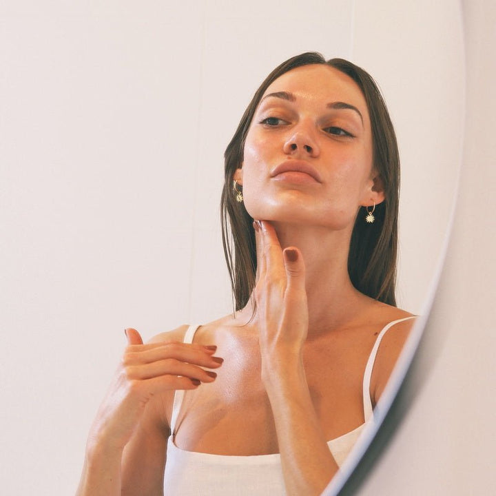 Wildcrafted Organics Rejuvenating Serum - model applying serum on neck