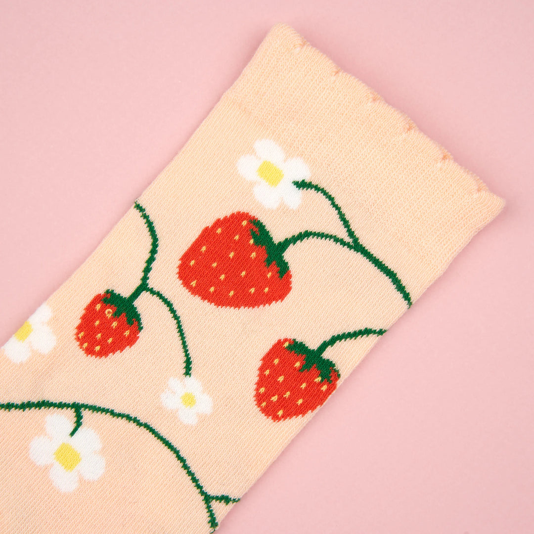 Strawberry Plant Socks von Coucou Suzette - Detailaufnahme vor rosanem Hintergund