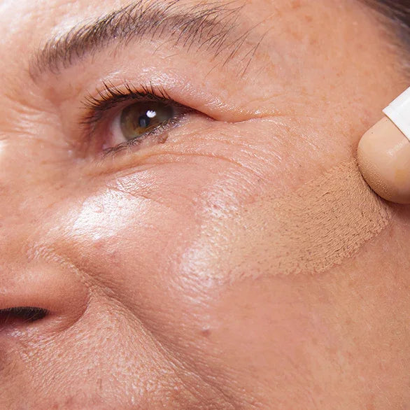 Model trägt Concealer Balm Nr. 5 Hazel auf - natürliche Abdeckung mit Mangobutter und Babassuöl