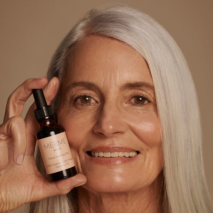 Merme Berlin Facial Healing Elixir Model holding oil