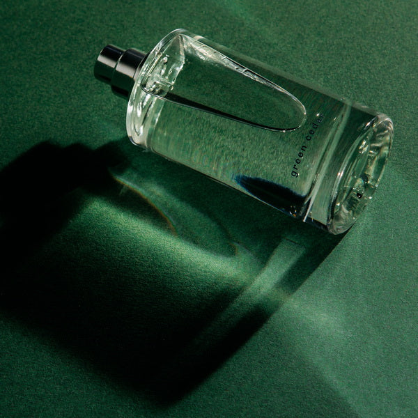 Abel Perfume Green Cedar lifestyle image flat on green surface