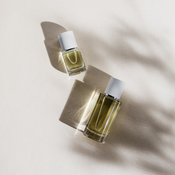 Abel White Vetiver Perfume regular und small size bottle lying flat on surface