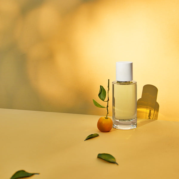 Abel Golden Neroli Perfume in orange light
