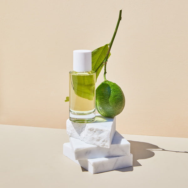 Abel White Vetiver Perfume on marble with limette