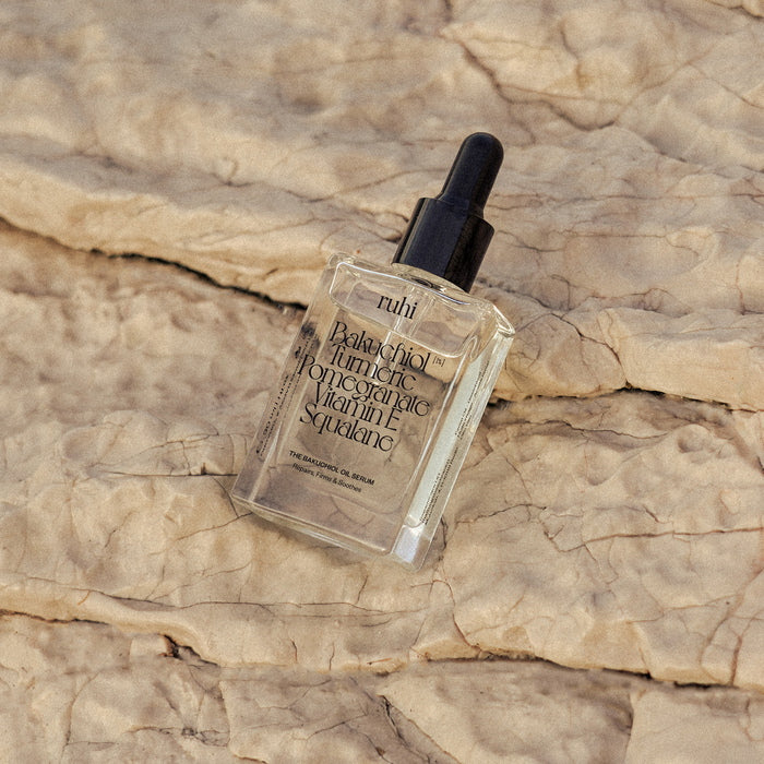 Ruhi Rituals The Bakuchiol Oil Serum on top of stone