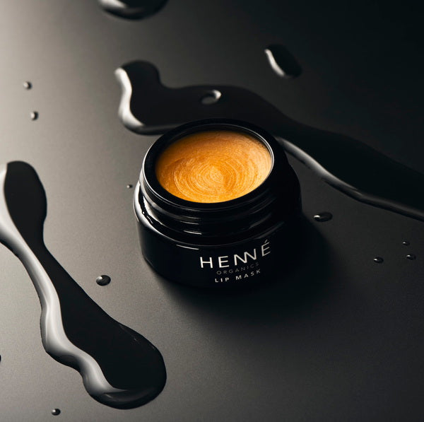 Henné Organics Lip Mask stylish photo of open jar on black surface