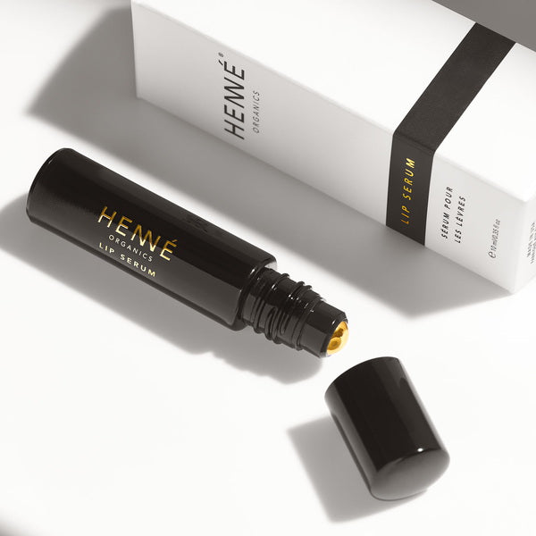 Henné Organics Luxury Lip Serum open flat on table with packaging